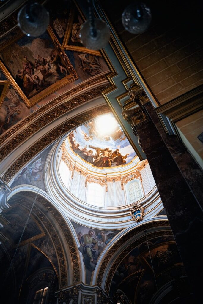 The ceiling of a church with a painting on it