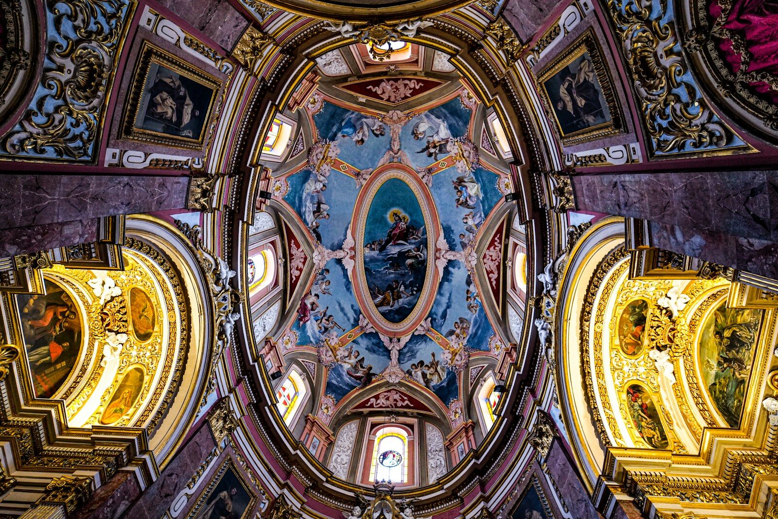 the ceiling of a church with paintings on it